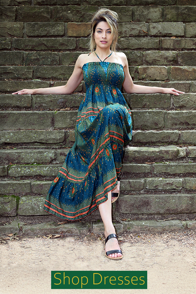 Model wearing a 'Barcelona Dress' green elastic top maxi dress, which features a bohemian print and a flowing silhouette. The image includes a 'Shop Now' button.
